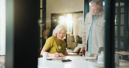 Documents, signature and taxes with old couple in home for retirement fund, mortgage payment and budget. Banking forms, savings account and pension review with senior man and woman in house for auditの写真素材