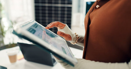 Woman, hands and solar power with tablet, chart or graph for monitoring renewable energy in office. Closeup, female person or employee with statistics for alternative future or eco monetizationの写真素材