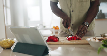 Hands, tablet or person meal prep with vegetables in home for healthy lunch, online recipe or cooking. Tech, chef and cut ingredients in kitchen for salad tutorial, website steps and culinary skillsの写真素材