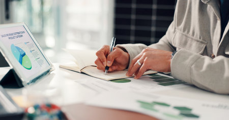 Hands, writing or tablet in office with planner for research, business growth plan and data analysis. Person, notes or problem solving with tech for profit generation, financial investment or graphs.の写真素材