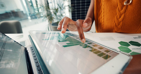 Employee, data and hands with tablet screen in office, sustainability or risk management on document. ESG consultant, paperwork and person with tech for environmental benefits and renewable energyの写真素材