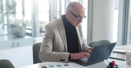 Laptop, research and typing with business man in office for insurance broker, risk assessment and report. Planning, premium policy and underwriter with mature person for claims coverage payoutの写真素材