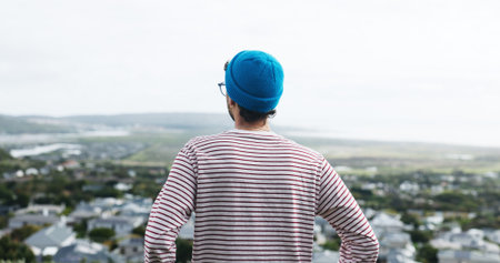 Perspective, outdoor or man view sunrise for inspiration, morning reflection or holiday thinking with space. Town observation, solitude or person with insight from vacation, vision or ideas from backの写真素材