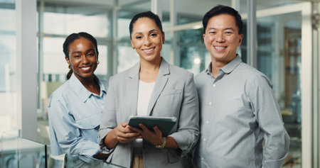 Happy, tablet and portrait of business people in office with teamwork for finance project. Smile, digital technology and professional manager with financial advisors for about us in workplace.の写真素材