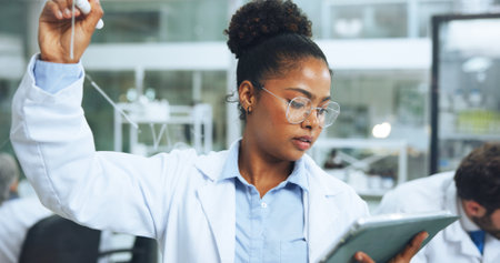 Glass wall, medical research and woman with tablet, science and experiment with digital report. Person, employee and scientist in lab, biotech and brainstorming equation with sample analysis and appの写真素材