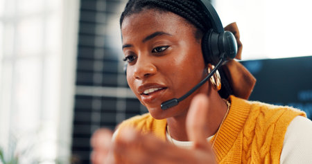 Customer care, black woman or talk with headset in contact center, help desk or service. Client...