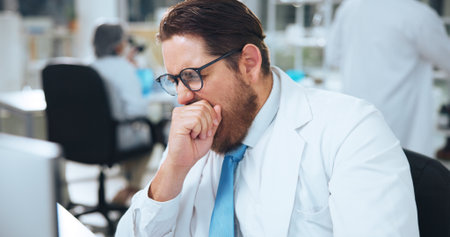 Scientist, tired man or yawn in lab with computer for research, problem solving or workload fatigue. Exhausted, person or employee with burnout from science fail, medical report or proposal deadline.の写真素材