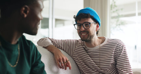 Happy men, friends and laugh on sofa with gossip for funny story, bonding together or weekend...