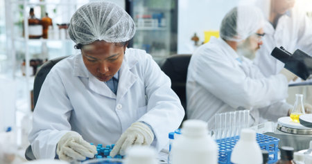 Woman, scientist and test tube with sample at lab for medical research, chemical or liquid for...