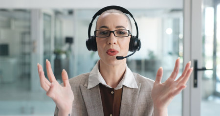 Woman, headset and call center at office, discussion or review with customer support at investment company. Person, broker and advisor in pov for portrait, voip and explain feedback for consultationの写真素材