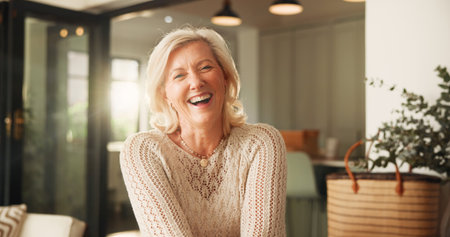 Relax, laughing and portrait of old woman in home or lounge for retirement, peace and confidence. Happiness, calm and weekend break with senior person in living room of apartment for funny jokeの写真素材
