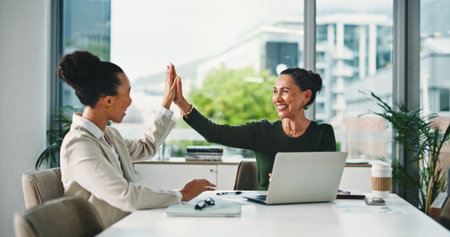 Laptop, high five and business women in office for meeting, finance report and collaboration. Tech,...