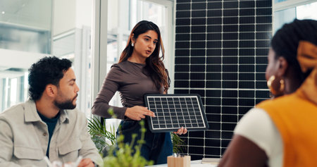 Pitch, proposal and solar panel with business woman in office for renewable energy initiative. Presentation, prototype and sustainability with employee in workplace for photovoltaic power productionの写真素材