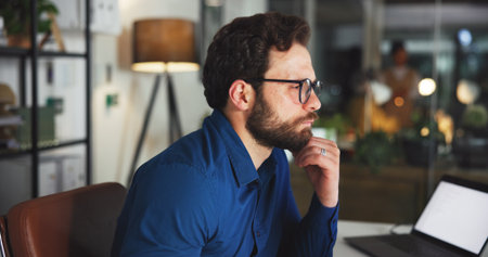 Online, thinking and glasses with business man in office for marketing campaign, night and news vision. Digital branding, reflection and bokeh with employee in media agency for article deadlineの写真素材