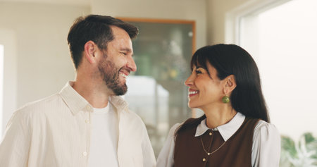 Love, connection and couple in house with smile, understanding or support in relationship. Romance, mature man and woman in lounge with happiness, commitment and bonding together in marriage.の写真素材