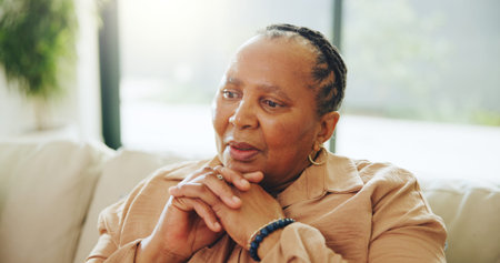 Home, senior black woman and thinking with memory, remember past or contemplation on sofa. Thoughts,...