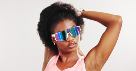 Stretching, thinking and black woman in studio for exercise, workout and training for mobility. Mockup space, sunglasses and person with warm up for wellness, health and fitness on white backgroundの写真素材