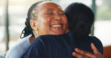 Embrace, caregiver and old woman in nursing home with smile, wellness checkup and trust in...
