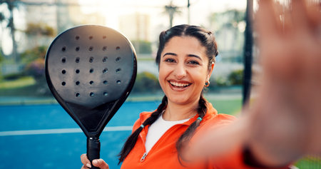 Padel, sports and selfie of woman on court for game, tournament and social media post outdoor. Tennis, athlete and person with photo, portrait and memory for training, exercise or workout for fitnessの写真素材