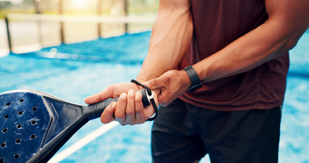 Wrist pain, hands or man with padel racket for sports injury, outdoor workout or strain for inflammation. Tennis court, poor technique or athlete with tendinitis from game, muscle tension or sprainの写真素材