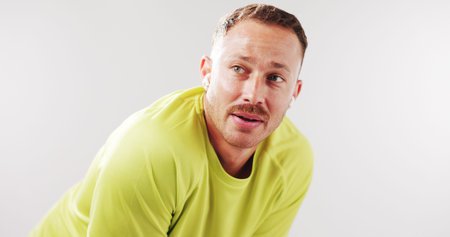 Tired, exercise and man in studio rest for recovery from fitness, training and workout. Mockup...