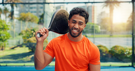 Padel, smile and fitness with portrait of man on court for sports athlete, contest and tournament club. Training, competition and tennis player or person on outdoor turf for exercise, game and matchの写真素材