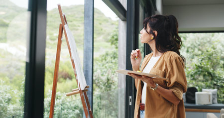 Woman, painting and thinking with canvas, easel or artwork for drawing or creative sketching in...