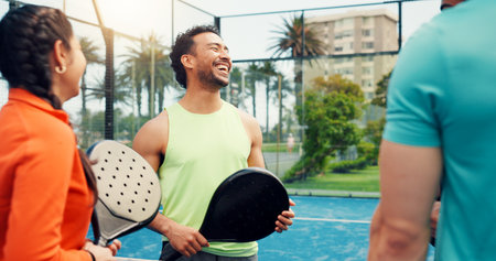 Padel, funny and people with fitness, conversation and laughing with smile, training and wellness. Outdoor, friends and tennis players with break, joke and discussion with feedback for tournamentの写真素材