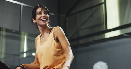 Padel, serve and smile with woman on court for workout, training and tournament club. Competition practice, exercise and challenge with low angle of mature person on turf for game and sports athleteの写真素材