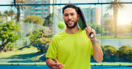 Smile, padel and portrait of man on court for fitness, training or match with confidence. Sports, happy and athlete with racket and ball outdoor for workout, practice or game with pride in Mexico.の写真素材