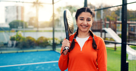 Padel, woman and smile with portrait on court for tournament practice, match contest or fitness. Sport event, tennis player and racket at wellness club for competition exercise or training with spaceの写真素材