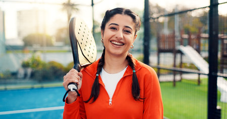 Padel, woman and happy with portrait on court for competition practice, match training or fitness. Sport event, tennis player and smile with racket at health club for tournament exercise and workoutの写真素材
