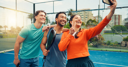 Padel, selfie and people with fitness, smile and training with profile picture, relax and peace sign. Friends, men and woman with photography, practice and sports competition with tournament memoryの写真素材