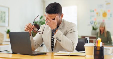 Man, laptop and headache with eye strain at startup, frustrated and stress with glasses at office....