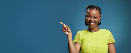 Portrait, pointing and black woman with smile in studio, show announcement or advertising with...
