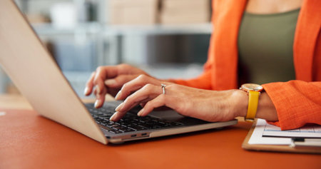 Hands, laptop and typing for logistics at startup, dropshipping and sales report at warehouse. Person, computer and inventory management for supply chain, stock or review with boxes at companyの写真素材