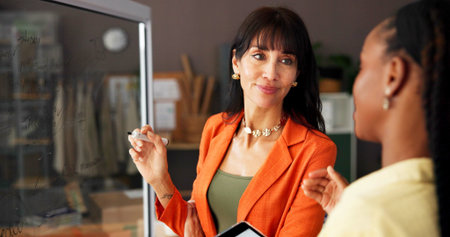 Woman, glass wall and discussion with team at warehouse, e commerce and tablet for sales review....