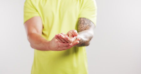 Person, fitness and hand pain with carpal tunnel in studio, inflammation or mockup space on white background. Runner, athlete and massage for muscle fatigue, arthritis and ache with training injuryの写真素材