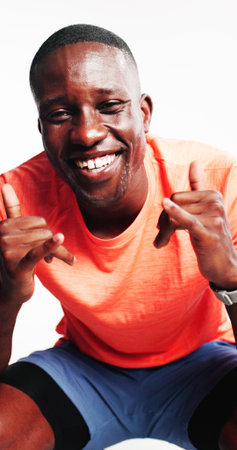 Hands, fitness and portrait of black man in studio with confidence for exercise, training and happy. Sports, athlete and person with shaka sign for wellness, health on white backgroundの写真素材