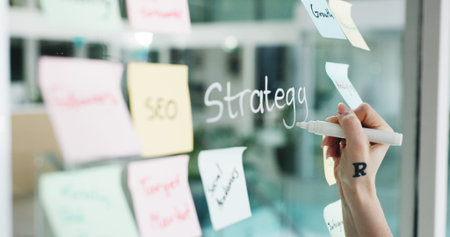 Branding, hands and writing on glass wall for business growth, seo plan and target audience trends....