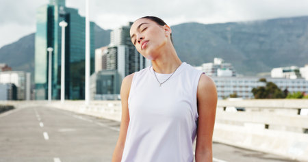 Stretching, runner and woman in city for exercise, marathon training and start workout outdoor. Sports, athlete and person with warm up for wellness, health and mobility for fitness in urban townの写真素材