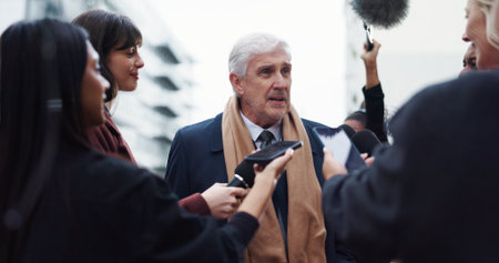 Politician, man or talk with reporter for election results announcement, campaign opinion or reaction. Mature person, crowd and media for politics discussion, question or mayor vote in New York City.の写真素材