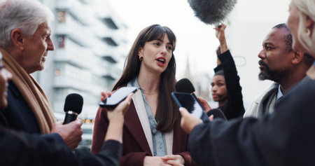 Woman, spokesperson and talking to press, city and journalists with election questions or discussion. Government, representative and outdoor with reporters for campaign updates and people with micの写真素材