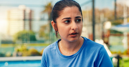 Woman, break and thinking at tennis court, sports and tired with breathing, reflection or training outdoor. Person, athlete and rest for perspective, fatigue and exercise with burnout at fitness clubの写真素材