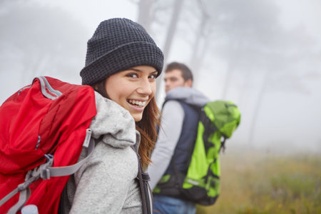 Portrait, smile and woman hiking in forest for travel, adventure and tourism with couple. Happy...