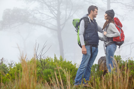 Couple, bonding and hike in nature, travel and people on adventure, backpacking and romance in woods. Outdoor, man and happy with woman on trip, love and travelers in forest, together or vacationの写真素材
