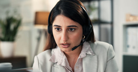 Woman, headset and talk with consultation at office, problem solving or contact at financial company. Person, advisor or broker with voip microphone, solution and review at asset management agencyの写真素材