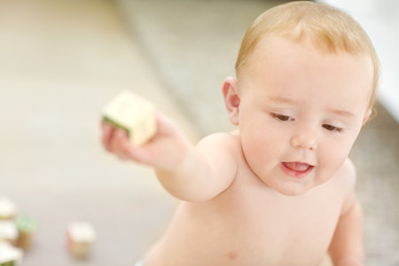 Building blocks, child development and playing with baby in home living room for education or growth. Game, learning and toys with infant kid in apartment for alphabet curiosity or motor skillsの写真素材