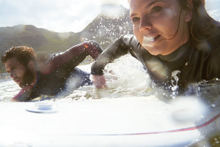 Athlete, couple and surfing with surfboard in ocean for travel, fitness adventure and riding waves....