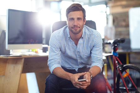 Marketing, portrait or man in office with phone, career pride or job goals in creative agency. Confidence, flare or director in branding firm with tech, about us and experience as media planner.の写真素材